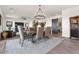 Open floor plan: view of a dining table, chandelier and sliding barn door at 11249 N Blakely St, Surprise, AZ 85388