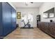Bright exercise room featuring a stationary bike, custom shelving and a wall mounted television at 11249 N Blakely St, Surprise, AZ 85388