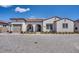 Charming single-story stucco home with a tile roof and an arched entryway at 11249 N Blakely St, Surprise, AZ 85388