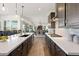 Gourmet kitchen with pendant lights, quartz countertops, and stainless steel appliances at 11249 N Blakely St, Surprise, AZ 85388