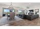 Open concept living room with wood floors, dining area and sliding glass doors at 11249 N Blakely St, Surprise, AZ 85388