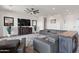 Spacious living room with ceiling fan, television and view of dining area at 11249 N Blakely St, Surprise, AZ 85388