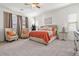 Comfortable main bedroom with plush carpet, neutral walls, and a cozy sitting area at 11249 N Blakely St, Surprise, AZ 85388