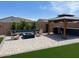 Backyard boasts an outdoor kitchen, artificial turf, a firepit and a gazebo at 11403 W Ashby Dr, Peoria, AZ 85383