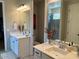 Bathroom with dual vanities, framed mirrors, and a separate shower area at 11403 W Ashby Dr, Peoria, AZ 85383