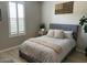 Cozy bedroom featuring wood floors, white shutters and stylish decor creating a comfortable retreat at 11403 W Ashby Dr, Peoria, AZ 85383