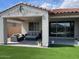 Cozy covered patio with comfortable seating and manicured artificial turf offers a relaxing outdoor experience at 11403 W Ashby Dr, Peoria, AZ 85383