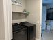 Convenient laundry room setup with modern appliances and ample shelving for storage at 11403 W Ashby Dr, Peoria, AZ 85383
