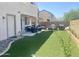 Large backyard featuring artificial turf, an outdoor seating area, and multiple grills at 11906 N 154Th N Ln, Surprise, AZ 85379