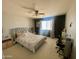 Comfortable bedroom with a ceiling fan, and a black accent wall at 11906 N 154Th N Ln, Surprise, AZ 85379