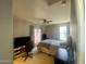 Comfortable bedroom with fan, natural light, television, work space, and an open feel at 11906 N 154Th N Ln, Surprise, AZ 85379