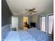 Bedroom with ceiling fan, walk in closet, mounted television, and access to patio at 11906 N 154Th N Ln, Surprise, AZ 85379