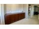 Upstairs hallway with a built-in wooden cabinet, leading to bedrooms and other living spaces in the home at 11906 N 154Th N Ln, Surprise, AZ 85379