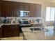 Kitchen features stainless steel appliances, granite countertops, and ample cabinet space, ideal for cooking at 11906 N 154Th N Ln, Surprise, AZ 85379