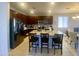 Spacious kitchen featuring a large island with seating, stainless steel appliances, and dark wood cabinets at 11906 N 154Th N Ln, Surprise, AZ 85379