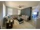 Spacious living room boasts a ceiling fan, large windows, and comfortable seating, offering plenty of space at 11906 N 154Th N Ln, Surprise, AZ 85379