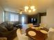 Open-concept living room and dining area with modern lighting and neutral decor at 11906 N 154Th N Ln, Surprise, AZ 85379