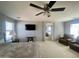 Large main bedroom featuring plush carpeting, a ceiling fan, and adjacent bathroom view at 11906 N 154Th N Ln, Surprise, AZ 85379