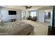A spacious main bedroom with plush carpeting, ceiling fan, and a view of a bathroom at 11906 N 154Th N Ln, Surprise, AZ 85379