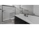 Modern bathroom featuring a walk-in shower, sleek vanity, and contemporary fixtures at 12332 W Parkway Ln, Avondale, AZ 85323