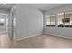Bedroom with wood flooring and large windows, seamlessly connecting to other rooms at 12332 W Parkway Ln, Avondale, AZ 85323