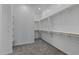 Spacious walk-in closet featuring carpeted flooring and abundant shelving and hanging storage at 12332 W Parkway Ln, Avondale, AZ 85323