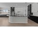 Modern kitchen with black and white cabinetry, marble countertops, and stainless steel appliances at 12332 W Parkway Ln, Avondale, AZ 85323
