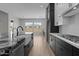 Contemporary kitchen design with a farmhouse sink, marble countertop, and modern gas range at 12332 W Parkway Ln, Avondale, AZ 85323