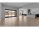 Open floor plan with tile floors, large sliding glass doors to backyard, and modern kitchen at 12332 W Parkway Ln, Avondale, AZ 85323