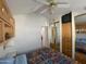 Bedroom with ceiling fan and view of cabinets and closet at 1318 W Chesapeake Dr, Apache Junction, AZ 85119
