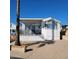 Charming single-story home featuring a covered porch with black railings and light green shutters at 1318 W Chesapeake Dr, Apache Junction, AZ 85119