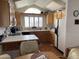 Bright kitchen with skylights, wood cabinets, and white appliances at 1318 W Chesapeake Dr, Apache Junction, AZ 85119