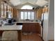 Bright kitchen with skylights, wood cabinets, and white appliances at 1318 W Chesapeake Dr, Apache Junction, AZ 85119