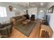 Spacious living room featuring comfortable seating, wood-style floors, and ample natural light at 1318 W Chesapeake Dr, Apache Junction, AZ 85119