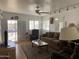 Inviting living room featuring cozy brown sofa, recliner, ceiling fan and laminate wood flooring at 1318 W Chesapeake Dr, Apache Junction, AZ 85119