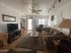Cozy living room with plush brown furniture, ceiling fan and decorative accents at 1318 W Chesapeake Dr, Apache Junction, AZ 85119