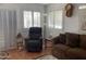 Comfortable living room with shutters on windows, brown sofa, and cozy recliner at 1318 W Chesapeake Dr, Apache Junction, AZ 85119