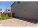 Paver patio and artificial turf in the backyard, enclosed by block wall and a gate at 14231 W Bronco Trl, Surprise, AZ 85387