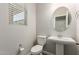 Well lit powder room featuring a pedestal sink, toilet, and window with blinds at 14231 W Bronco Trl, Surprise, AZ 85387