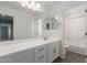 Bathroom with large vanity, dual mirrors and bronze hardware, and a shower/tub combo at 14231 W Bronco Trl, Surprise, AZ 85387