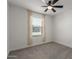 Neutral bedroom with soft carpet, ceiling fan, and a window allowing in plenty of light at 14231 W Bronco Trl, Surprise, AZ 85387