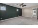Spacious carpeted bedroom with a ceiling fan, two windows, and neutral colored walls at 14231 W Bronco Trl, Surprise, AZ 85387