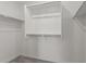 Walk-in closet with carpet and built-in shelving and hanging rods at 14231 W Bronco Trl, Surprise, AZ 85387