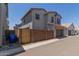 Home featuring a 2-car garage, desert landscaping and a private wooden gated entrance at 14231 W Bronco Trl, Surprise, AZ 85387