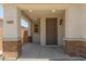 Covered front porch featuring stone posts, neutral color palette, and craftsman style door at 14231 W Bronco Trl, Surprise, AZ 85387
