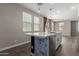 Kitchen island with bar seating, white countertop, blue base, and modern hardware at 14231 W Bronco Trl, Surprise, AZ 85387