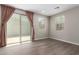 Bonus room with wood-look floors, neutral walls, sliding glass door to backyard at 14231 W Bronco Trl, Surprise, AZ 85387
