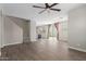 Open floor plan with wood-look floors connecting the living room, kitchen, and stairway at 14231 W Bronco Trl, Surprise, AZ 85387