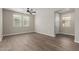 Spacious living room with wood-look floors, neutral walls, and plenty of natural light at 14231 W Bronco Trl, Surprise, AZ 85387