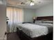 Cozy bedroom featuring a comfortable king-sized bed, ceiling fan, and bright natural light at 14922 W Port Au Prince Ln, Surprise, AZ 85374